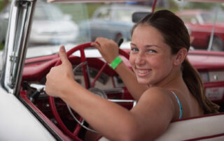 Portrait of a girl smiling in a car with natural light and shallow depth of field